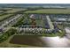 Aerial view of homes on a street with ponds, green spaces, and water views at 5425 Rainwood Meadows Dr, Apollo Beach, FL 33572