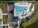 Aerial view showcasing community pool with modern lounge areas and inviting landscaping at 5425 Rainwood Meadows Dr, Apollo Beach, FL 33572