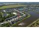 Aerial view of homes on a street with ponds, green spaces, and water views at 5425 Rainwood Meadows Dr, Apollo Beach, FL 33572