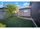 Landscaped backyard featuring green grass, stepping stones, and a mature shade tree at 5425 Rainwood Meadows Dr, Apollo Beach, FL 33572