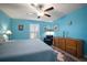 Serene bedroom with a ceiling fan, plantation shutters, and a comfortable armchair at 5425 Rainwood Meadows Dr, Apollo Beach, FL 33572