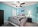 Cozy bedroom with a ceiling fan, plantation shutters, and soft carpeting at 5425 Rainwood Meadows Dr, Apollo Beach, FL 33572