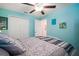Comfortable bedroom with a ceiling fan and a glimpse of an ensuite bathroom at 5425 Rainwood Meadows Dr, Apollo Beach, FL 33572