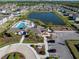 Primary-planned community showcasing a clubhouse, pool, playground, parking lot, and pond at 5425 Rainwood Meadows Dr, Apollo Beach, FL 33572