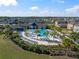 Resort-style community pool area surrounded by lush landscaping, lounge chairs, and inviting outdoor spaces at 5425 Rainwood Meadows Dr, Apollo Beach, FL 33572