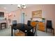 Modern dining area with black table and seating, adjacent to the kitchen at 5425 Rainwood Meadows Dr, Apollo Beach, FL 33572