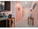 Inviting hallway features neutral tile flooring, soft pink walls with white trim, and decorative art at 5425 Rainwood Meadows Dr, Apollo Beach, FL 33572