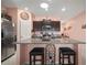 Kitchen boasts granite counters, stainless appliances, a wine rack, and bar seating at 5425 Rainwood Meadows Dr, Apollo Beach, FL 33572