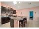 Bright kitchen with a skylight, center island with barstool seating, and sleek appliances at 5425 Rainwood Meadows Dr, Apollo Beach, FL 33572
