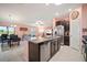 Open kitchen with granite island, stainless appliances, and adjoining dining area at 5425 Rainwood Meadows Dr, Apollo Beach, FL 33572