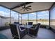 Relaxing screened lanai with ceiling fan, table, chairs, and a serene view of the outdoors at 5425 Rainwood Meadows Dr, Apollo Beach, FL 33572