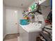 Bright laundry room featuring a washer, dryer, storage shelves and a convenient laundry sink at 5425 Rainwood Meadows Dr, Apollo Beach, FL 33572