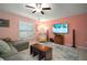 Inviting living room with plush seating, plantation shutters, and a ceiling fan at 5425 Rainwood Meadows Dr, Apollo Beach, FL 33572