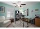 Well-lit office with wood-look floors, a ceiling fan, and a comfortable chair at 5425 Rainwood Meadows Dr, Apollo Beach, FL 33572