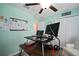 Practical office space with a large desk, a ceiling fan, and a comfortable chair at 5425 Rainwood Meadows Dr, Apollo Beach, FL 33572