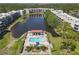 Aerial view of condo complex surrounding a pond with a pool area for community enjoyment in a scenic and tranquil environment at 5971 Terrace Park N Dr # 307, St Petersburg, FL 33709
