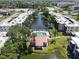 Community complex with a scenic pond, pool, and well-maintained landscaping in this aerial view at 5971 Terrace Park N Dr # 307, St Petersburg, FL 33709