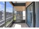 Screened balcony with tile floors offers an outdoor living space, complemented by views of the complex and blue skies at 5971 Terrace Park N Dr # 307, St Petersburg, FL 33709