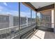 Outdoor screened-in balcony with tile flooring provides relaxing space with views of complex buildings and palm trees at 5971 Terrace Park N Dr # 307, St Petersburg, FL 33709