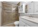 Updated bathroom features a glass-enclosed shower with tile surround, and a modern vanity with storage at 5971 Terrace Park N Dr # 307, St Petersburg, FL 33709