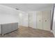 Spacious bedroom showcasing wood-look flooring, closet storage, and versatile layout options at 5971 Terrace Park N Dr # 307, St Petersburg, FL 33709