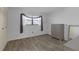 Bright bedroom with wood-look flooring, a window, and ample closet space, providing comfort and functionality at 5971 Terrace Park N Dr # 307, St Petersburg, FL 33709