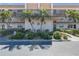 Charming condo building with palm trees, balconies, and well-maintained landscaping at 5971 Terrace Park N Dr # 307, St Petersburg, FL 33709