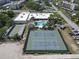 Aerial view of community featuring a sparkling pool, tennis courts and shuffleboard for active lifestyles in a well-kept setting at 5971 Terrace Park N Dr # 307, St Petersburg, FL 33709