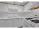Bright kitchen with white cabinets and modern appliances at 5971 Terrace Park N Dr # 307, St Petersburg, FL 33709
