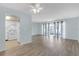 Spacious living room with new floors and access to a private balcony at 5971 Terrace Park N Dr # 307, St Petersburg, FL 33709
