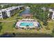 A picturesque aerial shot of the community pool with palm trees and a red roof gazebo at 5971 Terrace Park N Dr # 307, St Petersburg, FL 33709