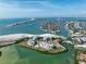 Expansive aerial view showcasing waterfront residences, sandy beaches, and serene waterways amidst lush vegetation and island landscapes at 755 Collany Rd # 504, Tierra Verde, FL 33715