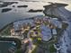 Stunning aerial view of luxury condominiums surrounded by water and lush landscaping at dusk at 755 Collany Rd # 504, Tierra Verde, FL 33715