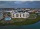 Stunning aerial view of a waterfront condo complex with a pool, lush landscaping, and serene water views at 755 Collany Rd # 504, Tierra Verde, FL 33715