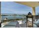 Relaxing covered balcony with lounge seating and clear views of the water, perfect for enjoying the coastal scenery at 755 Collany Rd # 504, Tierra Verde, FL 33715