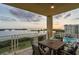 Balcony featuring outdoor dining set and sunset views of the water at 755 Collany Rd # 504, Tierra Verde, FL 33715