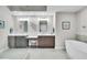 Modern bathroom featuring a large vanity, stand alone tub, and glass enclosed shower at 755 Collany Rd # 504, Tierra Verde, FL 33715