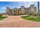 Attractive building with lush landscaping, circular driveway, and prominent signage at 755 Collany Rd # 504, Tierra Verde, FL 33715
