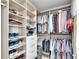 Organized walk-in closet with shelves and hanging rods for optimal storage and easy access to clothes and shoes at 755 Collany Rd # 504, Tierra Verde, FL 33715