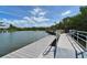 Picturesque waterfront view with a private dock and lush greenery against a blue sky at 755 Collany Rd # 504, Tierra Verde, FL 33715