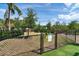 A fenced dog park features lush turf, shade trees and convenient waste disposal stations at 755 Collany Rd # 504, Tierra Verde, FL 33715