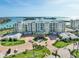 Beautiful exterior view of a condo building with manicured landscaping,circular drive and ocean view at 755 Collany Rd # 504, Tierra Verde, FL 33715