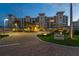 Elegant condominium building with tropical landscaping and circular driveway leading to a welcoming entrance for residents and guests at 755 Collany Rd # 504, Tierra Verde, FL 33715