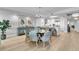 Open-concept interior with dining area, white walls, wood flooring and stainless appliances at 755 Collany Rd # 504, Tierra Verde, FL 33715