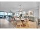 Open-concept great room featuring dining area and living room with water view and natural light at 755 Collany Rd # 504, Tierra Verde, FL 33715