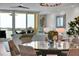 Bright open concept great room with light wood floors, dining area, ceiling fan and large sliding doors at 755 Collany Rd # 504, Tierra Verde, FL 33715
