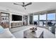 Spacious living room features modern furnishings, decor, and sliding glass doors to the outdoor patio and water views at 755 Collany Rd # 504, Tierra Verde, FL 33715