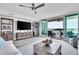 Spacious living room with modern decor, water view, large windows, and natural light at 755 Collany Rd # 504, Tierra Verde, FL 33715