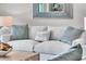 Comfortable living room features a plush sofa, textured pillows, and stylish decor at 755 Collany Rd # 504, Tierra Verde, FL 33715