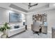 Bright home office features stylish décor with desk, sofa, ceiling fan, and artwork, creating a comfortable workspace at 755 Collany Rd # 504, Tierra Verde, FL 33715